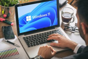 professional typing on laptop with windows 11